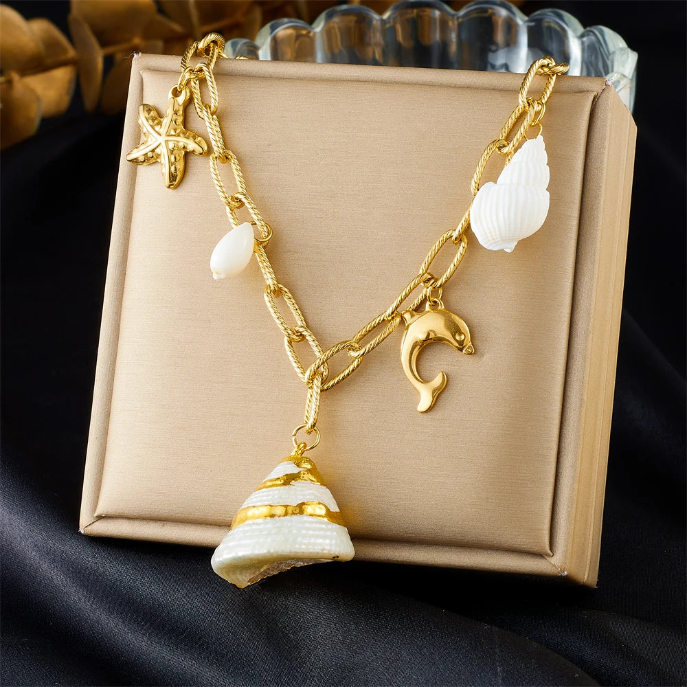 Layered gold dolphin and cone shell necklace